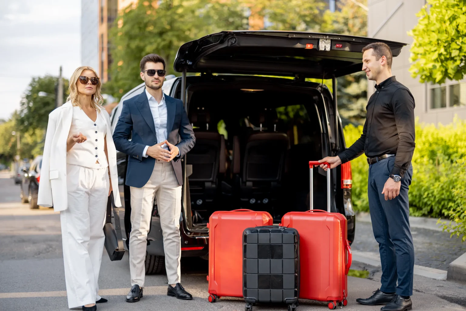 Three individuals standing beside a car, surrounded by luggage, ready for their journey.